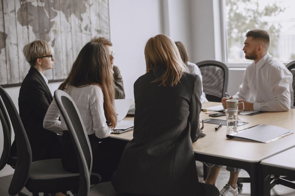 Colleagues in a productive meeting at a modern office, fostering teamwork and collaboration.